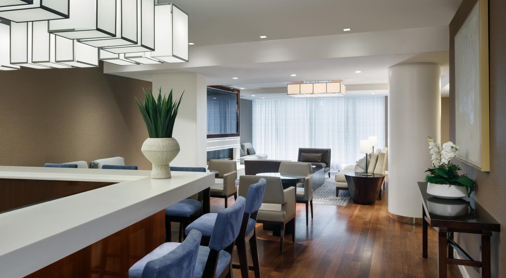 Settle into comfort at The Larstrand a room with a table chairs and a chandelier