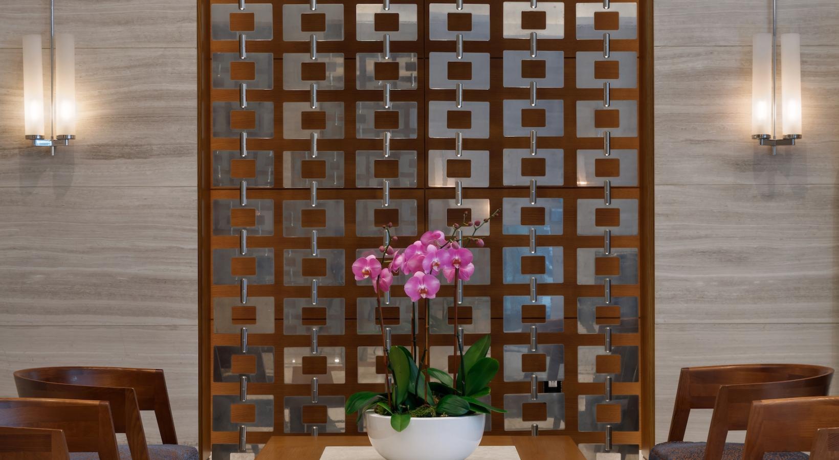 Enjoy our resident-only features a table with a potted plant on it in a room with chairs