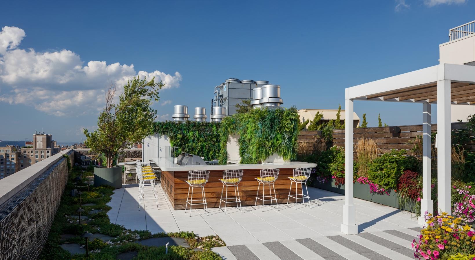 Enjoy our resident-only features a patio with tables and chairs on it with a building in the background
