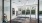 a glass walled building with a sign